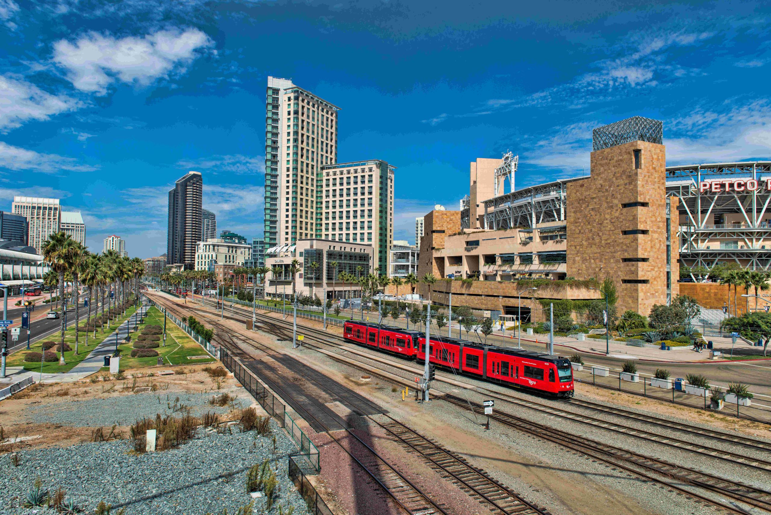 Panoramic photo of part of San Diego. Shows cityscape and train railroad.