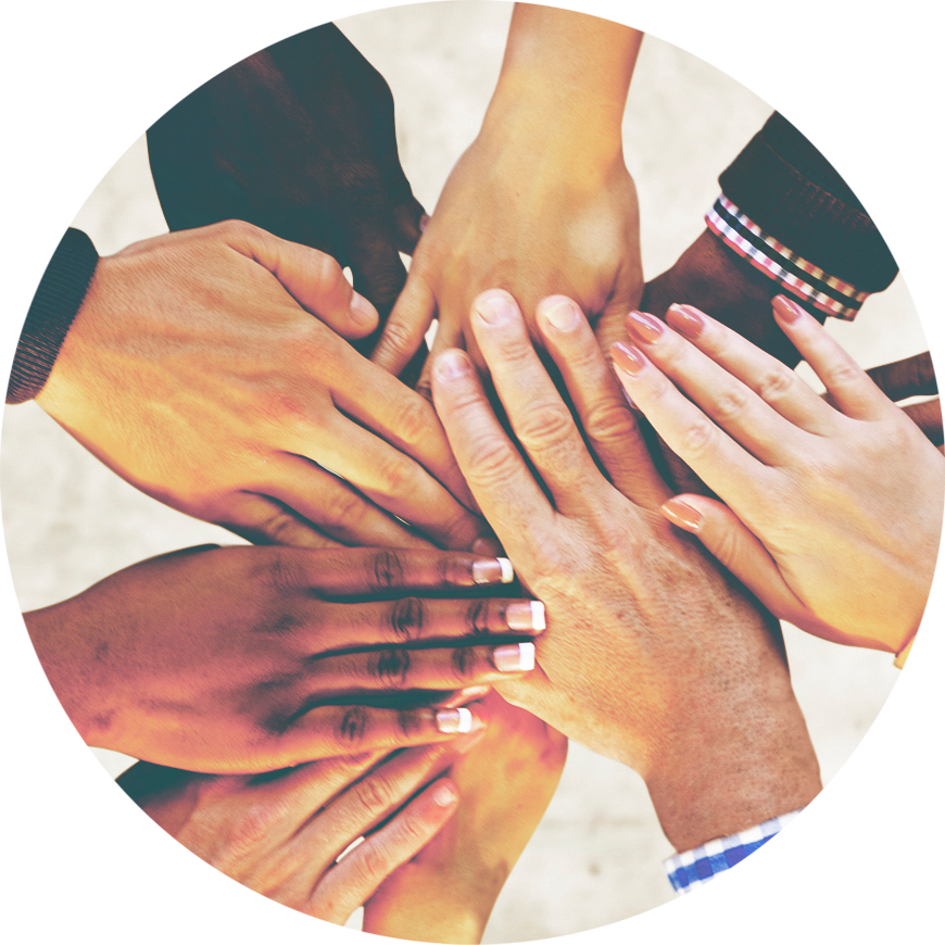 A photo of many hands on top of each other in a "All hands together" photo.